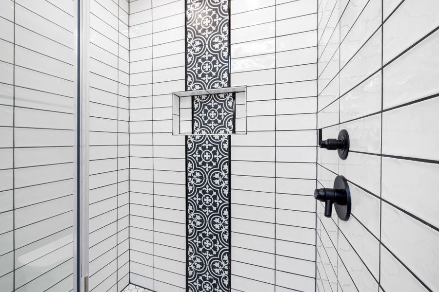 Newly tiled walk-in shower with matte black fixtures